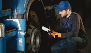 Worker checks quality of wheel in garage